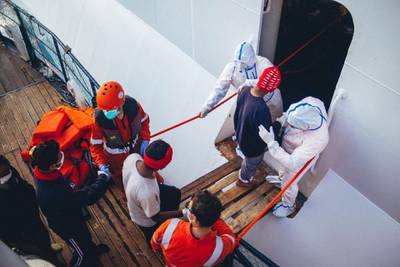 Rescued migrants are taken aboard an Italian passenger ship nearly two weeks after being rescued. Sea-Eye
