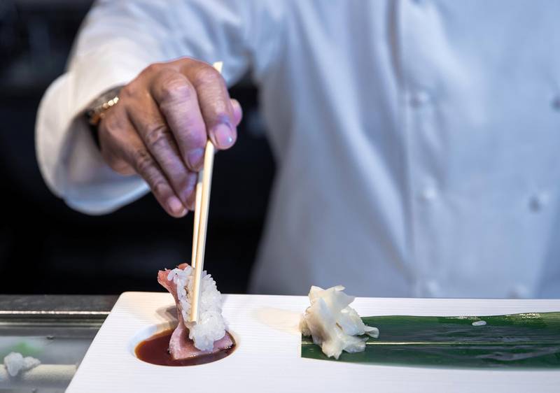 Dubai, U.A.E., September 27, 2018.  Chef Nobu at his restaurant at the Atlantis, the Palm. --  Chef Nobu demonstrates how to use chopsticks while eating sushi properly.Victor Besa/ The NationalSection:  IFReporter:  Selina Denman