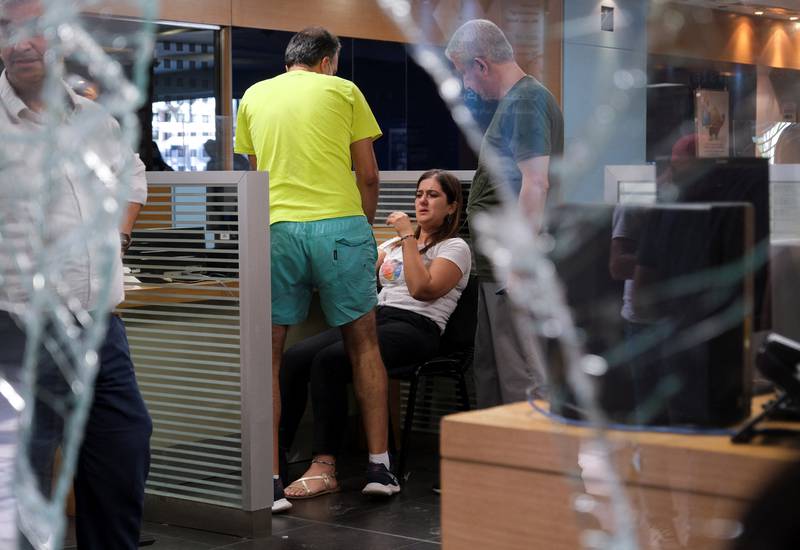 A woman is comforted after a group of depositors stormed Blom Bank in the Lebanese capital. Reuters
