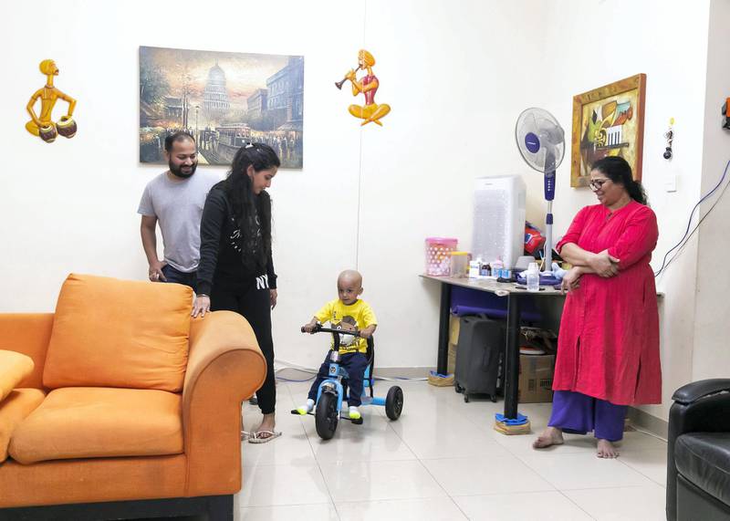 DUBAI, UNITED ARAB EMIRATES. 19 APRIL 2020. Aarev Shetty, 2, rides his tricylce. He just returned from the hospital after receiving his cancer treatment. His dad, Sushant Shetty, mom, Anu Rai, and grandmother, Shakuntala Shetty stand by him. (Photo: Reem Mohammed/The National)Reporter:Section: