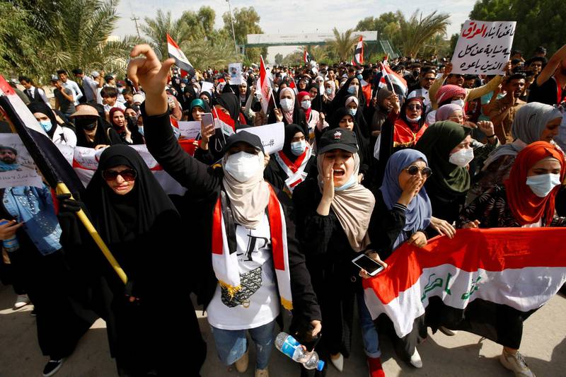 Iraqi demonstrators shout slogans as they gather to mark the first anniversary of the anti-government protests in Najaf, Iraq. Reuters