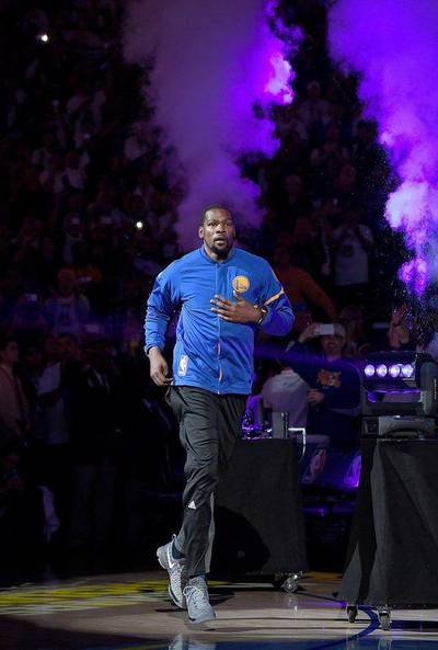 Kevin Durant of the Golden State Warriors runs onto the court during player introductions. Thearon W Henderson / Getty Images / AFP