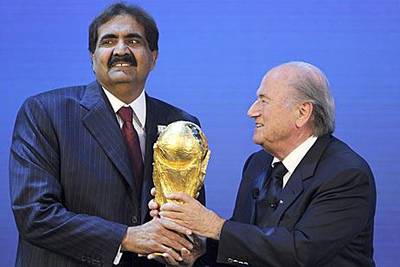The Emir of Qatar, Sheikh Hamad bin Khalifa Al Thani, left, and Sepp Blatter, the Fifa president hold the World Cup trophy after Qatar were announced as the hosts for the 2022 World Cup.