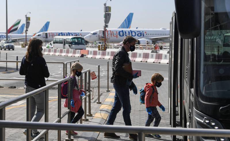 Passengers bound for Frankfurt board a shuttle bus at Dubai International Airport. AFP