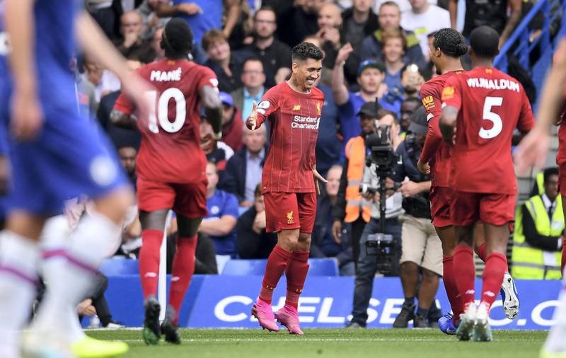 LONDON, ENGLAND - SEPTEMBER 22: Roberto Firmino of Liverpool celebrates with teammates after scoring his team's second goal during the Premier League match between Chelsea FC and Liverpool FC at Stamford Bridge on September 22, 2019 in London, United Kingdom. (Photo by Laurence Griffiths/Getty Images)
