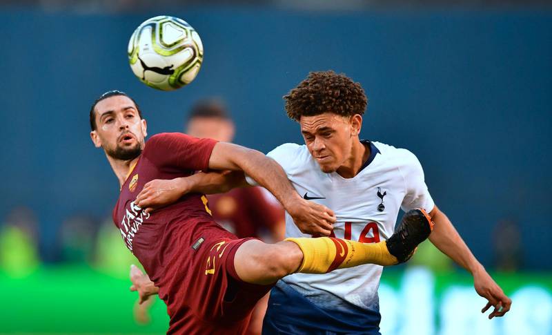 Tottenham's Luke Amos vies for the ball with Roma's Javier Pastore. AFP