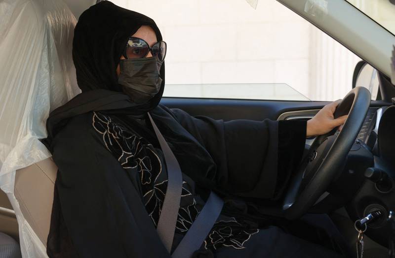 Taxi driver Fahda Fahd sits in her car in Saudi Arabia's capital, Riyadh.  Like other Saudi women, Ms Fahd couldn't legally drive until 2018, but her lime-green Kia now gives her a way to make extra cash as living costs soar in the conservative kingdom.  All Photos: AFP