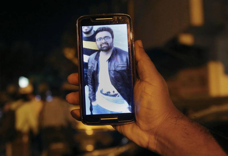 A relative shows a picture of Syed Areeb Ahmed, a Pakistani citizen who was killed. AP Photo