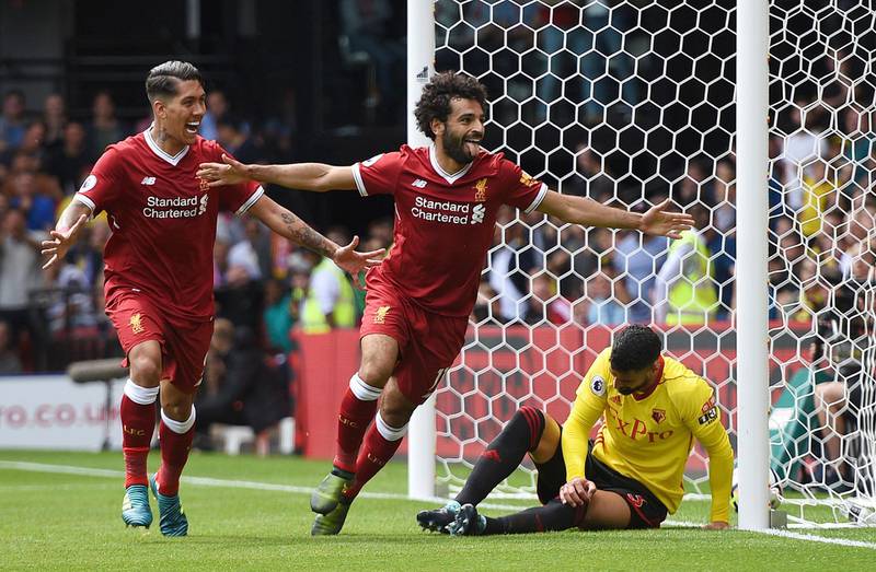 Liverpool's Mohamed Salah, center, celebrates scoring his side's third goal during the English Premier League soccer match at Vicarage Road, Watford, England, Saturday, August 12, 2017. (Daniel Hambury/PA via AP)