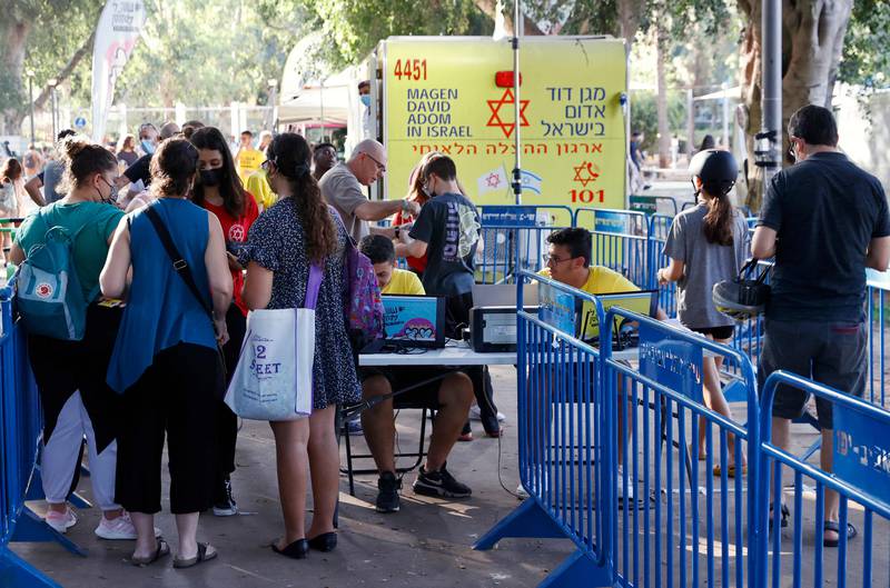 Israeli youths arrive to receive a dose of the Pfizer/BioNTech Covid-19 vaccine.