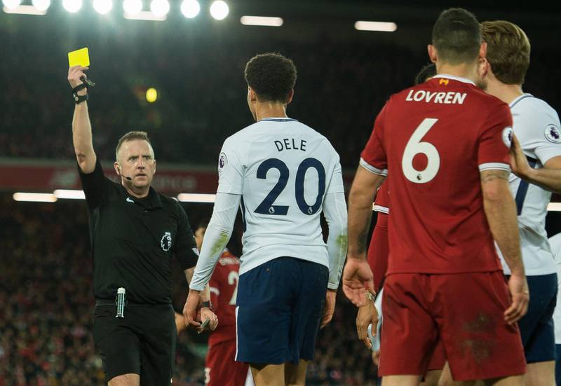 epa06496559 Tottenham Hotspur’s Dele Alli (2-L) receives a yellow card from referee Jon Moss (L) during the English Premier League soccer match between Liverpool and Tottenham Hotspur in Liverpool, Britain, 04 February 2018.  EPA/PETER POWELL EDITORIAL USE ONLY. No use with unauthorized audio, video, data, fixture lists, club/league logos or 'live' services. Online in-match use limited to 75 images, no video emulation. No use in betting, games or single club/league/player publications EPA/PETE