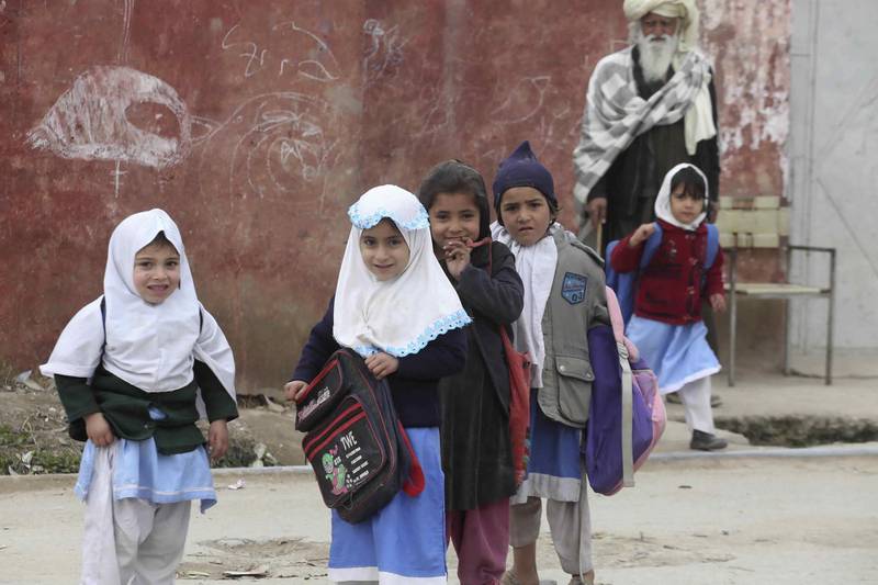 Afghan schoolgirls leave their school in the Kabobayan refugee camp in Peshawar, Pakistan. AP Photo