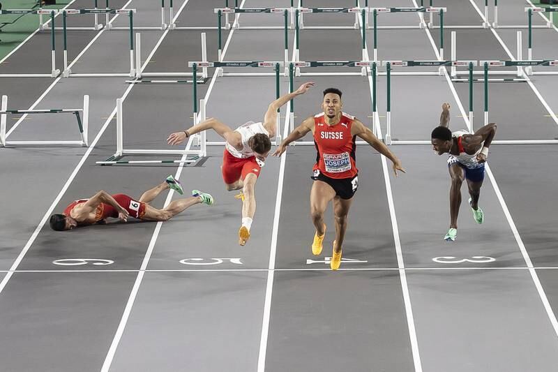 Jason Joseph wins as Enrique Llopis (L) lies on the track after crashing out of the men's 60m hurdles final at the European Athletics Indoor Championships in Istanbul. EPA