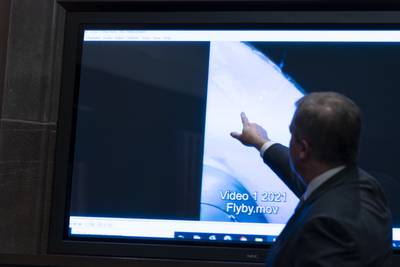 Deputy Director of Naval Intelligence Scott Bray points to a video display of an unexplained aerial phenomenon during a 2022 hearing. AP