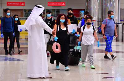 Tourists arrive at Dubai airport as the emirate reopened its doors to international visitors. AFP