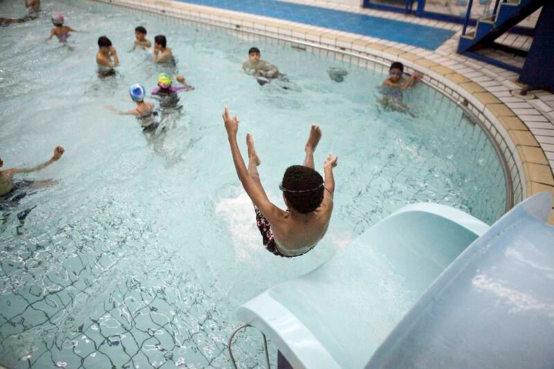 Abu Dhabi, United Arab Emirates, December 31, 2012: 
Children play in the indoor swimming pool at the Armed Forces Officers Club  in Abu Dhabi, on Monday, Dec. 31, 2012.
Silvia Razgova/The National

Note: for a story on the condition of pools in the UAE.