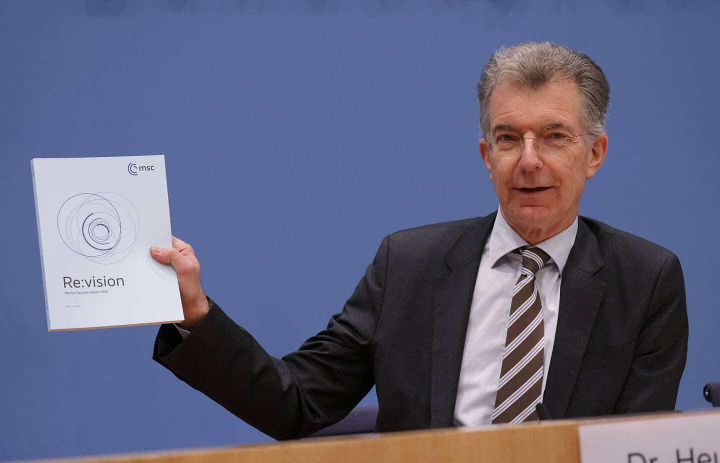 Conference chairman Christoph Heusgen holds a copy of the 2023 Munich Security Report. Getty 