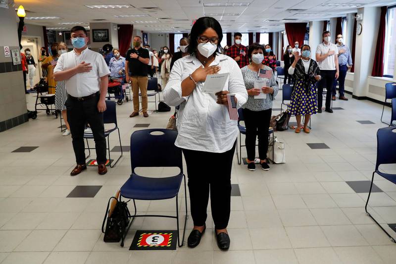 Ifeoma Eh, a candidate from Nigeria who has applied for US citizenship, stands with others during naturalisation ceremony in New York City. Reuters