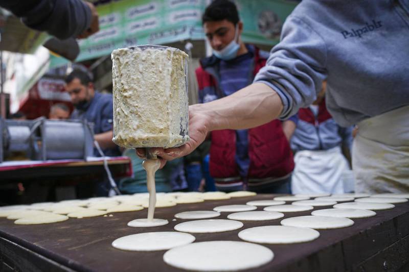 In Gaza City, Palestinian vendors prepare traditional sweets known as qatayef, a dumpling filled with cream or nuts, during a fasting month affected by the coronavirus pandemic. AFP
