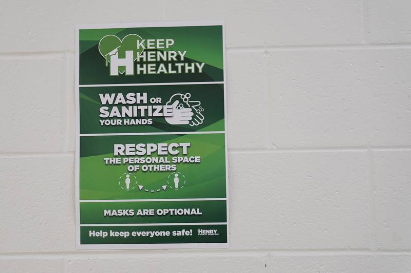 A sign hanging in the hallway reads "Keep Henry Healthy, wash or sanitize your hands, repeat the personal space of others and masks are optional" at Tussahaw Elementary school on August 4, 2021, in McDonough, Georgia, US. AP