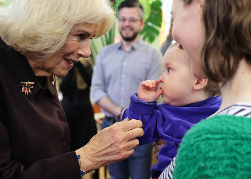 Queen Consort Camilla meets a mother and child at Refugio Cafe in Berlin. AFP