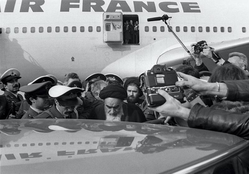 (FILES) Photo taken 01 February 1979 at Tehran airport of revolutionary leader Ayatollah Ruhollah Khomeini (C) surrounded by journalists after leaving the Air France Boeing 747 jumbo that flew him back from exile in France to Tehran. Iran is set to buy the plane, a government newspaper said 29 January 2006. Although Iran's US-backed shah had already fled the country when Khomeini returned from exile in the small French town of Neauphle-le-Chateau, the 747's landing is seen as the true start of the Islamic revolution. AFP PHOTO GABRIEL DUVAL (Photo by GABRIEL DUVAL / AFP)
