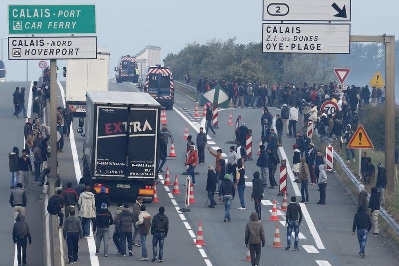 Migrants hoping to board lorries at the Calais ferry terminal in France, trying to get to England. Photo: Reuters