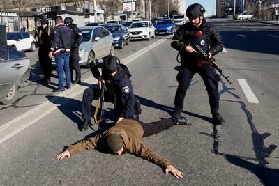 Police officers check occupants of a suspicious car in Kiev, as Russia's invasion of Ukraine continues. Reuters