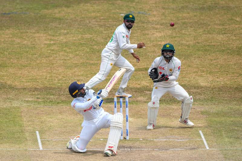 Sri Lanka's Dhananjaya de Silva plays a shot as Pakistan wicketkeeper Mohammad Rizwan and captain Babar Azam look on. AFP