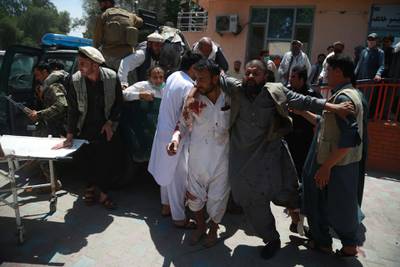 People shift injured victims of a suicide bomb attack to a hospital in Jalalabad, Afghanistan.  EPA