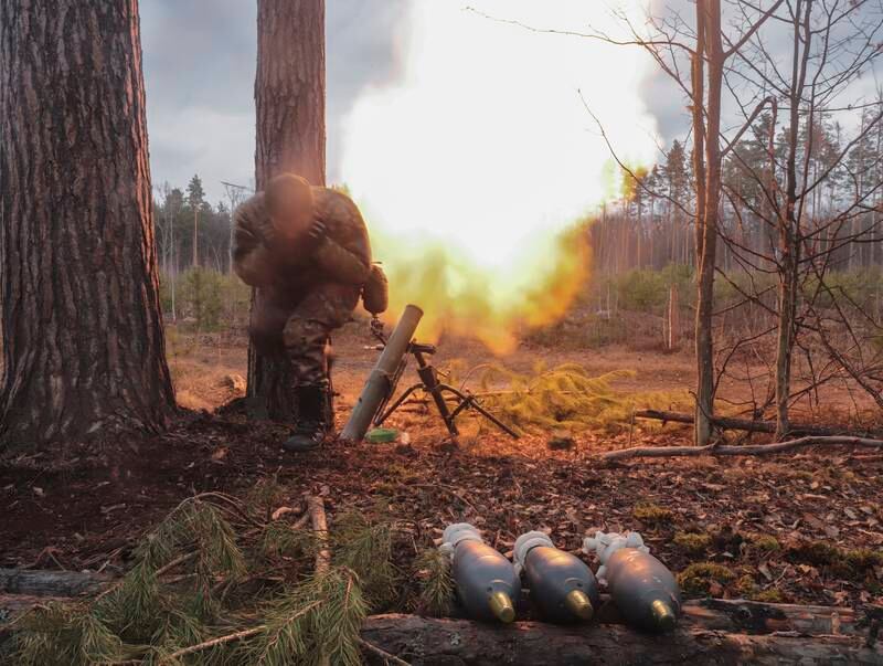 A Ukrainian soldier shoots at the Russian positions not far from the capital Kyiv. EPA