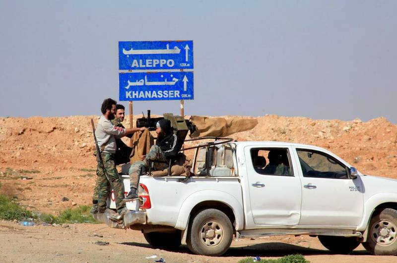 Syrian pro-government forces advance on a road through the town of Khanasser, which is the sole link between government-held areas in and around Aleppo and those in the rest of the country. Georges Ourfalian / AFP 



