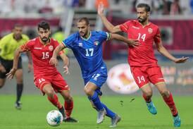 Kuwaiti striker Bader Al Mutawa slides past two Bahrain players in the Arabian Gulf Cup on December 2, 2019. Karim Jafaar / AFP