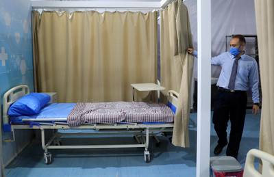 An employee looks at a bed area at the Ain Shams field hospital prepared to receive Covid-19 patients in Cairo, Egypt. Reuters