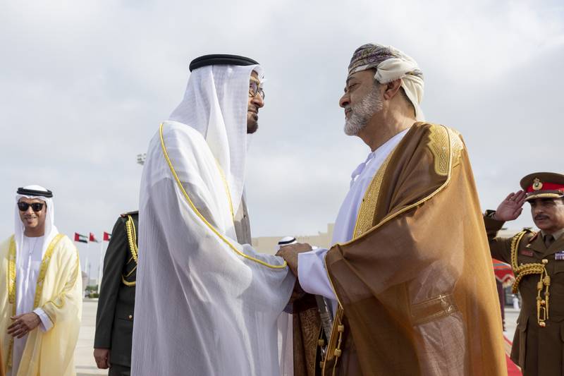 Sheikh Mohamed and Sultan Haitham shake hands. 