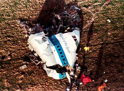 Police and investigators look at what remains of the nose of Pan Am 103 in 1988.