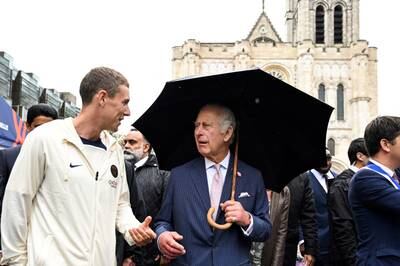 King Charles speaks with a member of the Paris Saint-Germain Foundation in Saint-Denis. Reuters