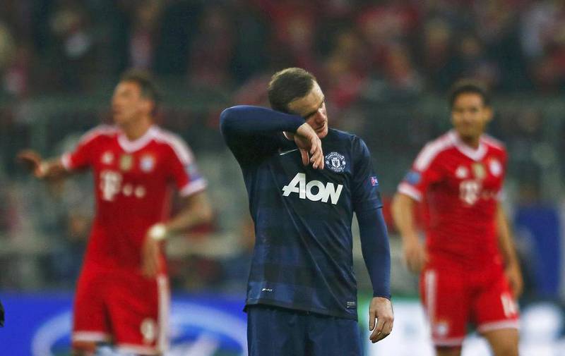 Manchester United's Wayne Rooney, centre, reacts after the Uefa Champions League quarter-final second leg against Bayern Munich on April 9, 2014. Michael Dalder / Reuters