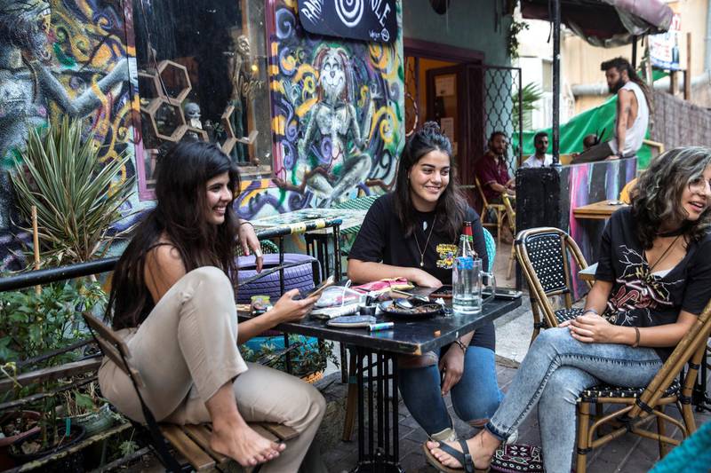 Eden Kavishy, 22, with Eman Atshi ,18, (center) at a table with friends at a chic cafe on Mossadeq Street in Haifa, a northern city thatÕs a cultural center of Arab and Palestinian life in Israel.
All in the group were Druze, an Arab religious minority group centered in Israel, Lebanon and Syria.
Atshi voted for Blue and White in April, but this time around sheÕs not voting at all.
ÒI voted last time and it didn't help,Ó she said of her decision to stay home and boycott.
(Photo by Heidi Levine for The National).