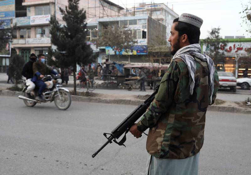 A Taliban fighter stands guard at the site of a blast in Kabul, Afghanistan.  Reuters