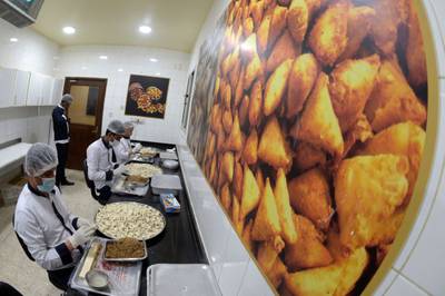 Workers prepare sweet sambosa at Hussain Showaiter Sweets in northern Bahrain.