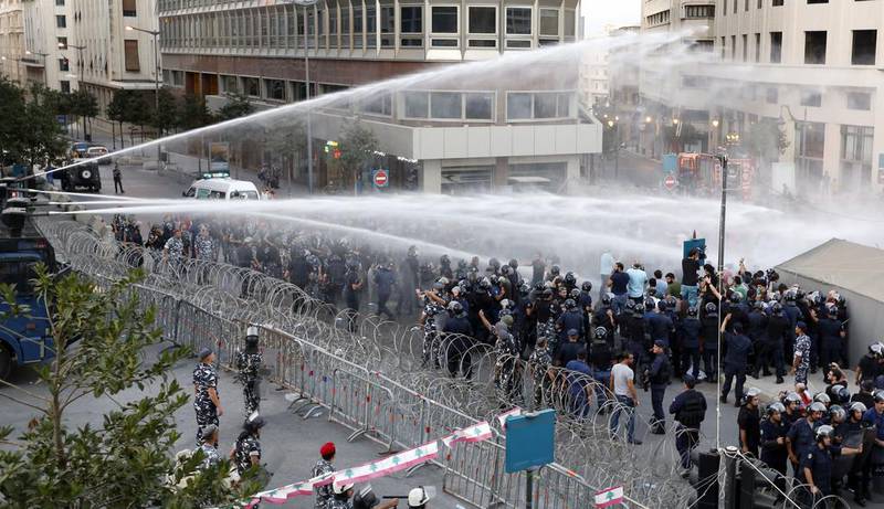Lebanese security forces use water cannons to disperse protesters during a demonstration, organised by the “You Stink” campaign, against the ongoing waste crisis. Anwar Amro / AFP