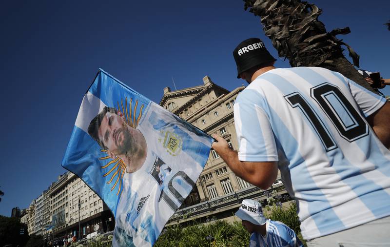 An Argentina fan with a Lionel Messi flag at the victory parade. Reuters