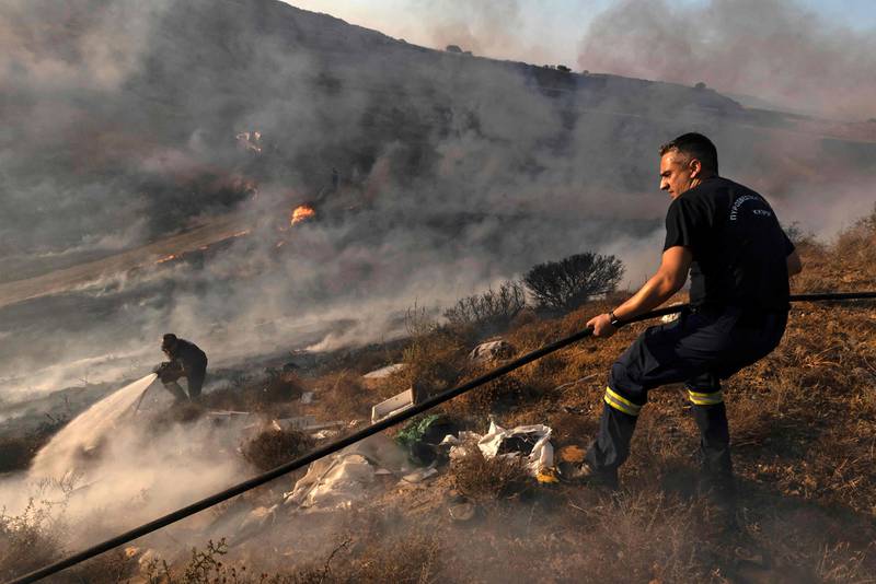 Wildfires rage in Cyprus in 2021. The report found that the private sector could help governments around the world reduce loss of life by preparing vulnerable communities for extreme weather events. Iakovos Hatzistavrou 
/ AFP