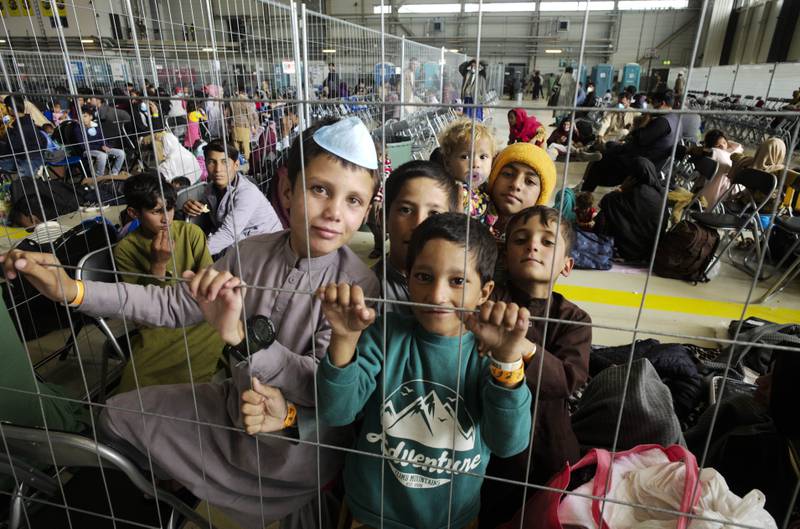 Children from Afghanistan wait to fly to the US or another safe location inside a hangar at the US  Air Base in Ramstein, Germany.  AP