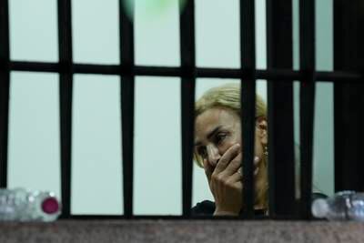 A woman held hostage in the bank cries. AP