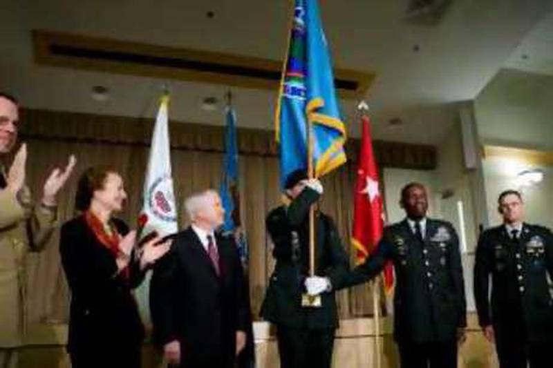 An unidentified Army solider holds the colors for the U.S. Africa Command Unified Command as Joint Chiefs Chairman Michael Mullen, from left, Henrietta H. Fore, Administrator of USAID and Director of Foreign Assistance for the State Department, Defense Secretary Robert M. Gates, Army Gen. William E. "Kip" Ward, Commander U.S. Africa Command, and the command's senior enlisted solider, Command Sgt. Maj. Mark S. Ripka applaud during an activation ceremony, Wednesday, Oct. 1, 2008, at the Pentagon in Washington. (AP Photo/Haraz N. Ghanbari) *** Local Caption ***  DCHG110_Africa_Command.jpg