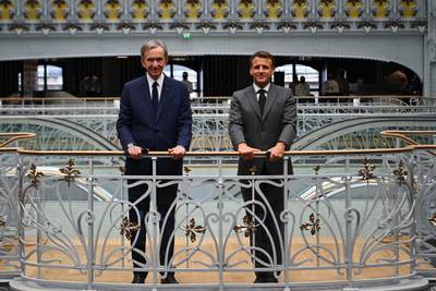 Reopening the store after 16 years, French President Emmanuel Macron, right, and head of French multinational corporation LVMH, Bernard Arnault, stand inside the restored building. AFP