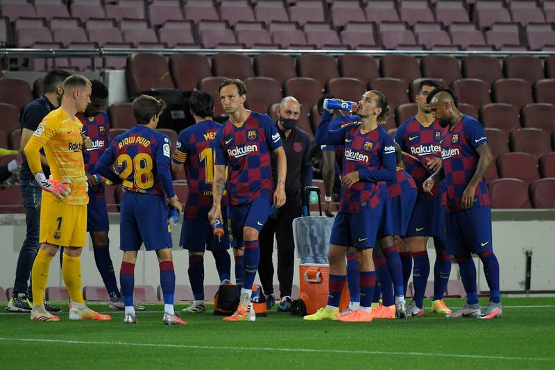 Barcelona's players drink during a hydration pause . AFP