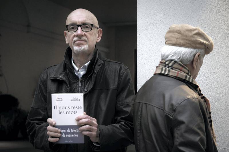 This photograph taken on January 13, 2020, shows Georges Salines (L) and Azdyne Amimour (R) prior to an interview about their book "Il nous reste les mots", a dialogue between the father of a victim and that of a Bataclan terrorist, in Paris. - Salines, lost his daughter Lola at the Bataclan on November 13, 2015, and Azdyne Amimour, is the father of one of the three terrorists of the concert hall attack. (Photo by Philippe LOPEZ / AFP)